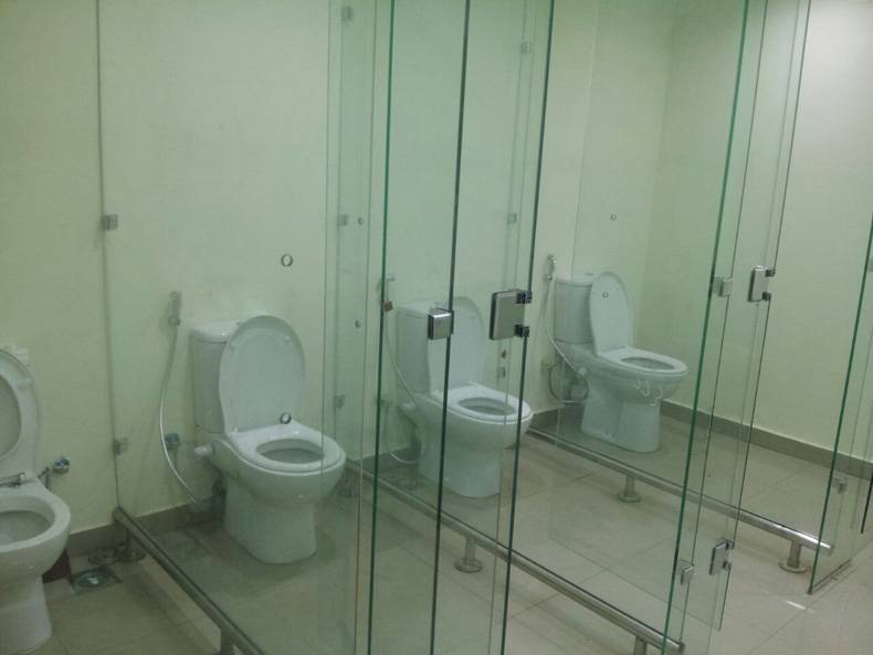 An image of a public bathroom with glass walls.